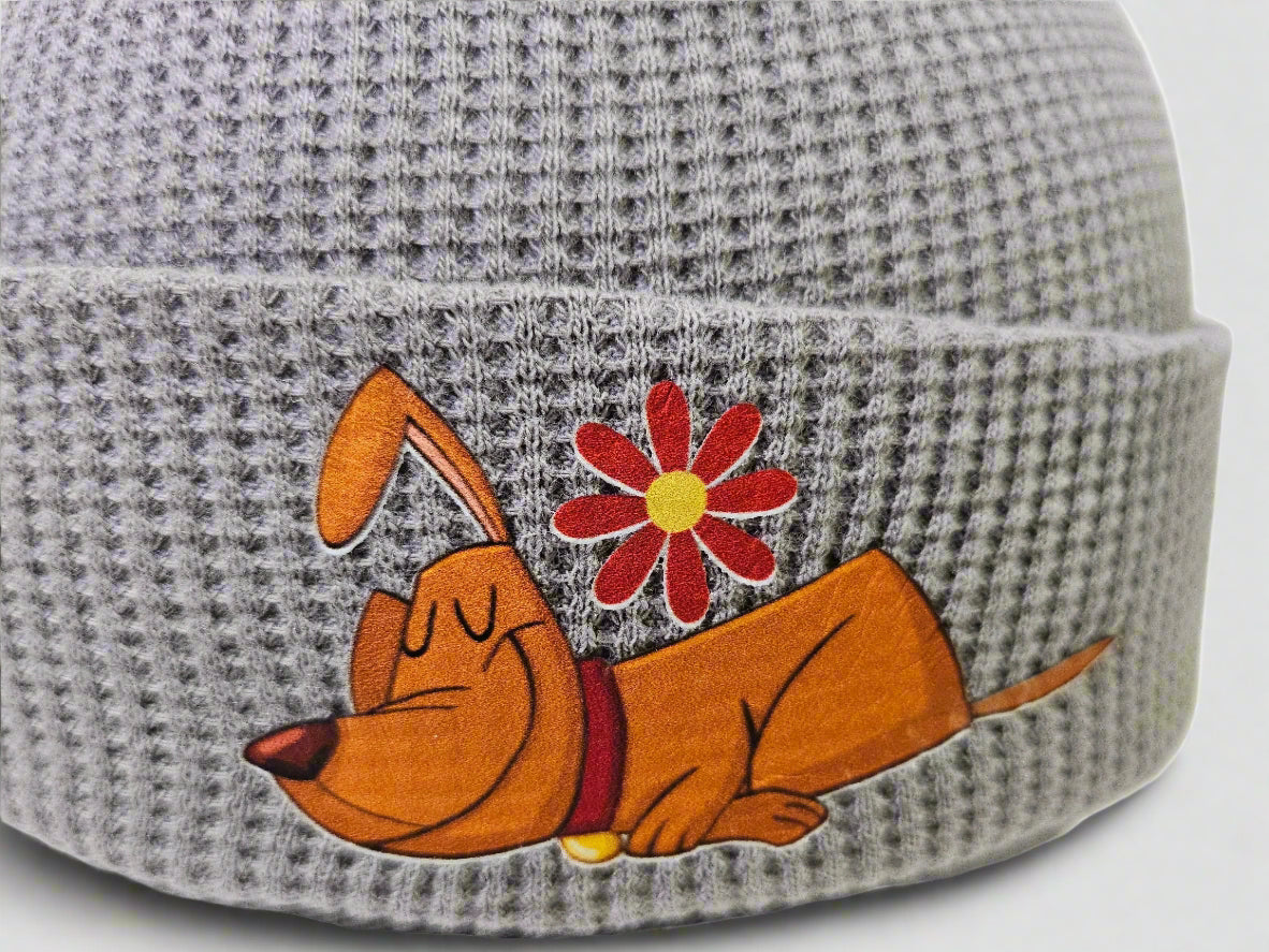 Gray beanie with a cartoon dog and flower design on a white background