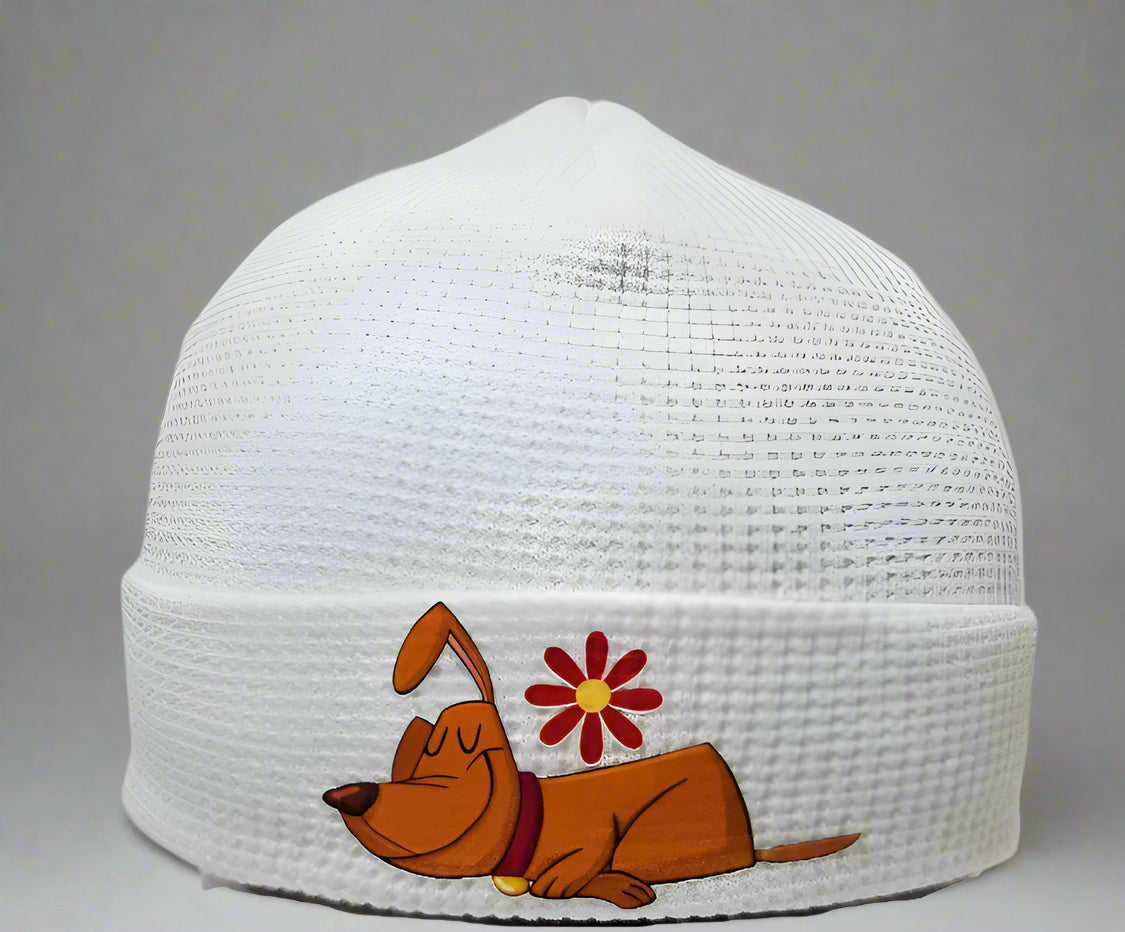 White beanie with a cartoon dog and flower design on a gray background