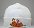 White beanie with a cartoon dog and flower design on a gray background